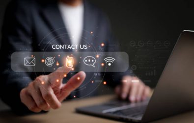 Businessman using a laptop and touching on virtual screen contact icons consists of telephone, email, address, live chat, internet wifi, Contact us or Customer care support hotline people connect.